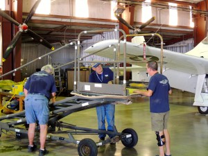 John Meyer, Lyle Thornton and Brent Collins work on a "newly discovered" hydraulic lift.