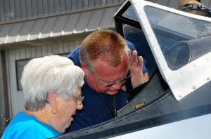 Mark Haskin makes sure that Ms. Shirley Qualia is secure before taking off.