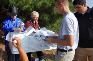 HSW member, and Lee HS JROTC Commander, Barbara Blevins, helps distribute breakfast burritos to her cadets and others who participated in the Riders4Fighters wave off on Friday morning.