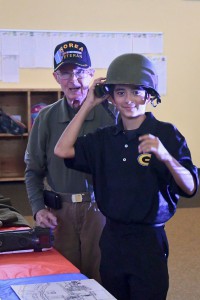 A Grady Student Council member tries on a helmet, with H.A. Tuck looking on.