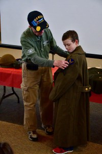 H.A. Tuck explains the shoulder patch to a young Grady student.